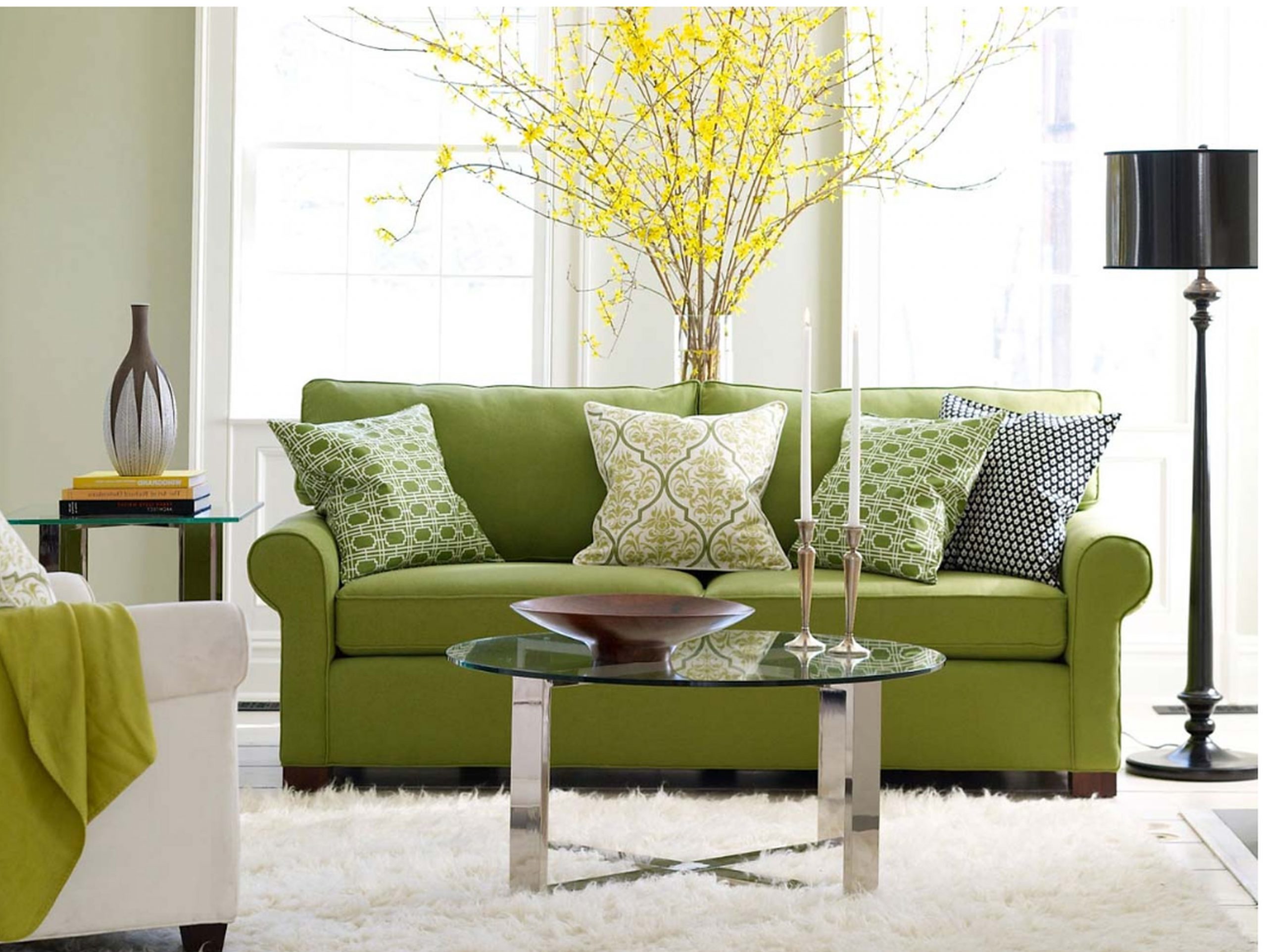 Green sofa in living room with yellow plant behind